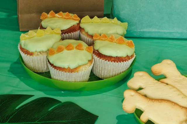 cupcakes with green icing and yellow and purple spikes across the middle