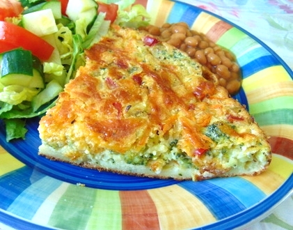 The picture shows a slice of Possible Vegetable Pie served with a tossed salad and baked beans.