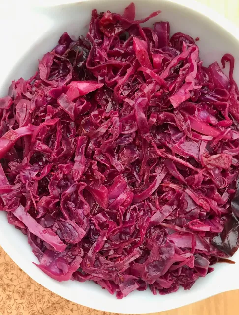 Close-up of a prepared bowl of braised red cabbage with cranberries and maple.