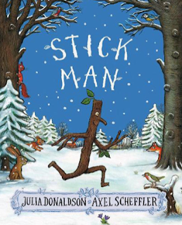 A screen shot of the front cover of Stick Man. By Julia Donaldson and Axel Scheffler. The picture shows a stick with arms, legs, and a face, running through a snowy forest.