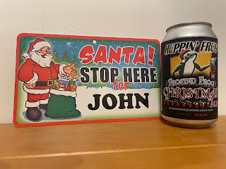 A can of Hoppin' Frog's Frosted Frog and a sign that reads "Santa stop here for John!"