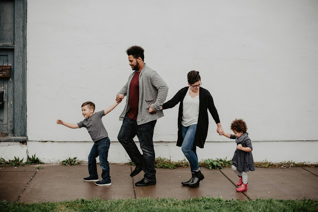 family-of-four-walking-at-the-street
