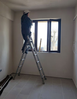 Bekir fitting the blind in Rosie's bedroom