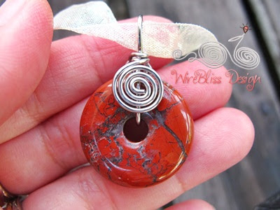 holding the wire wrapped Jasper donut pendant