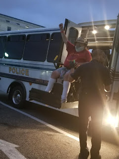 ADAPT person being arrested with fist in the air