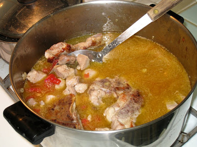 Return pork to the pot, add stock, tomatoes and hominy