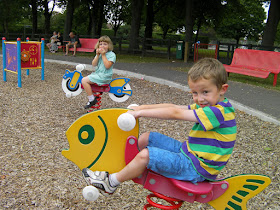 eating an apple on the bouncy seats in the park