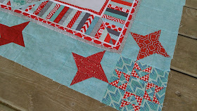 red and aqua string star round robin quilt