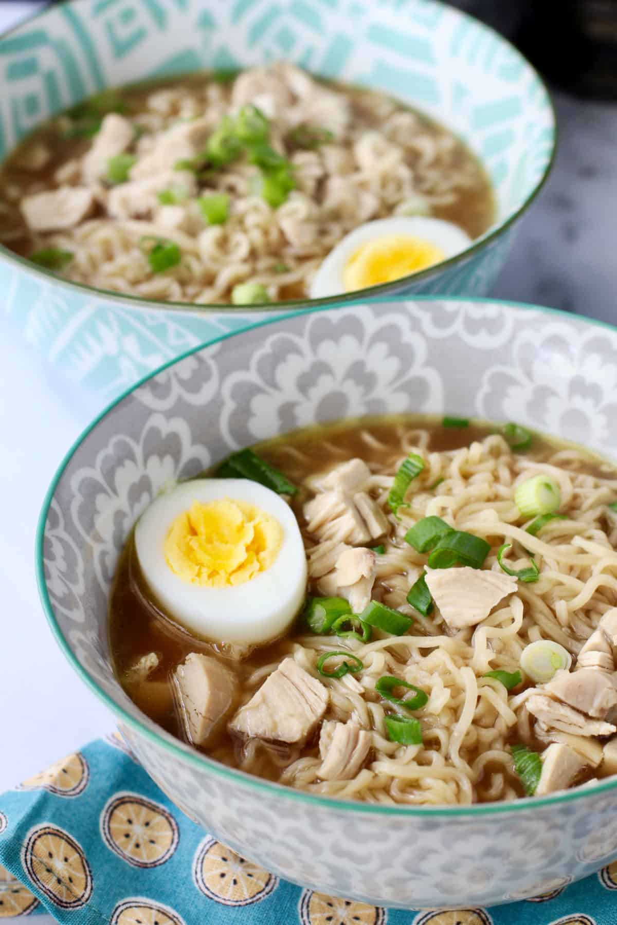 Rotisserie Chicken Ramen in two bowls with boiled eggs on top.