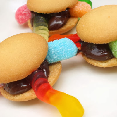 A few simple ingredients and a super-easy prep make these sweet cookie "burgers." Let the kids help you ice the cookies and add the deliciously-disgusting gummy worms.