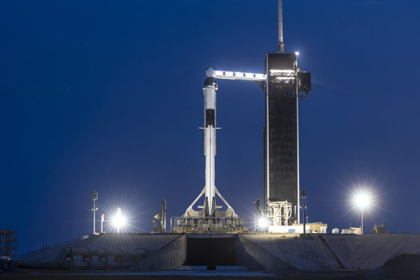 SpaceX's Falcon 9 rocket, with the Crew Dragon Demo-2 capsule at the top, sit quietly at Kennedy Space Center's Launch Complex 39A on the evening of May 25, 2020.