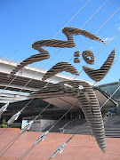 The running athlete symbolises, the spirit of Sydney, the Olympic torch . (sydney emblem)