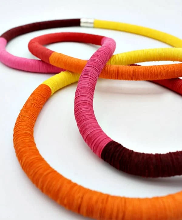 rope-like paper necklace made of punched circles in vibrant colors