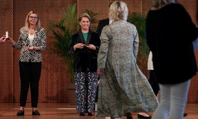 Grand Duchess Maria Teresa wore an Alamaro envers satin jumpsuit by Max Mara Studio. Dries Van Noten printed trousers