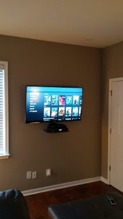 Flatscreen TV mount installation with component shelf