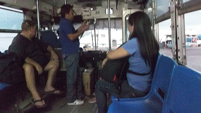 passengers and a port staff on board the transfer bus at Cebu Pier 1