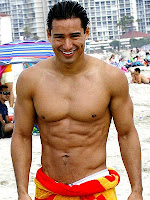 Mario Lopez showing off his six pack on the beach