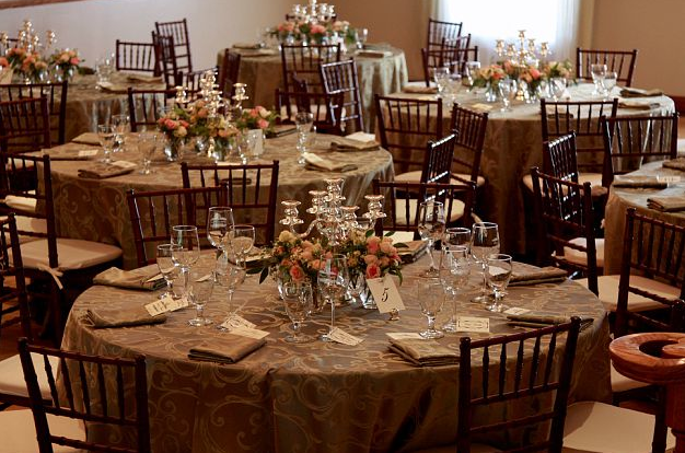 Silver candelabras surrounded by sweet arrangements of peach roses with 