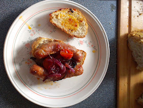 Home-cooked bread with caramelised onion, tomato and sausages