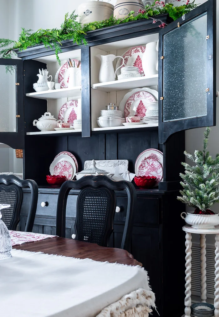 black hutch, red and white dishes