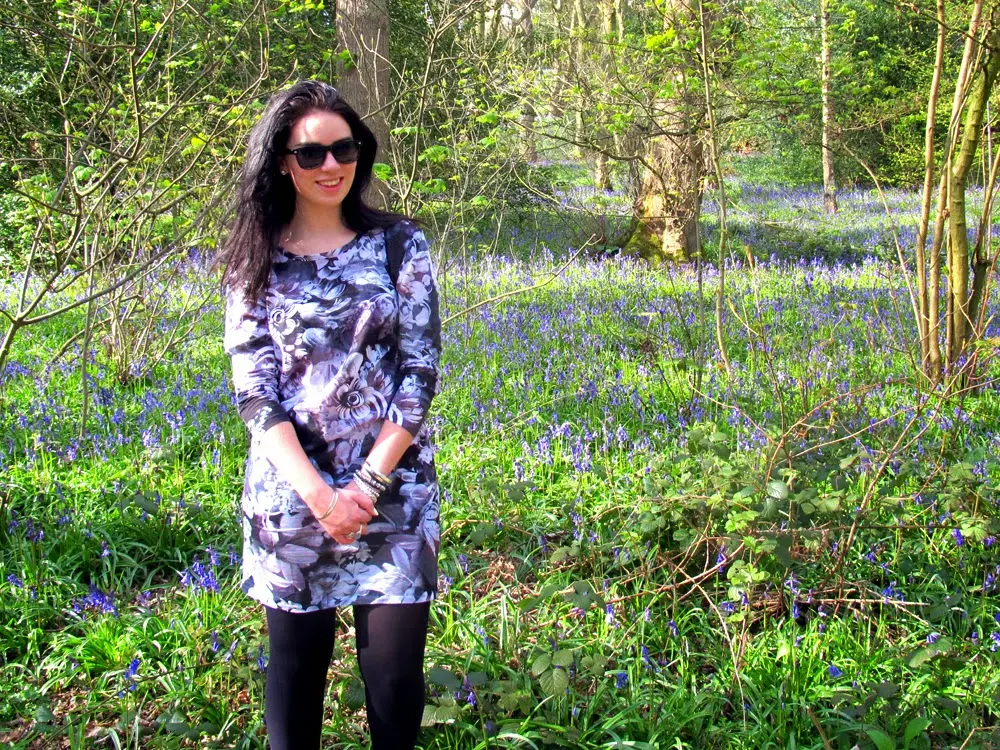 Emma Louise Layla wearing Paul Smith purple rose print dress in Ilkley bluebell woods