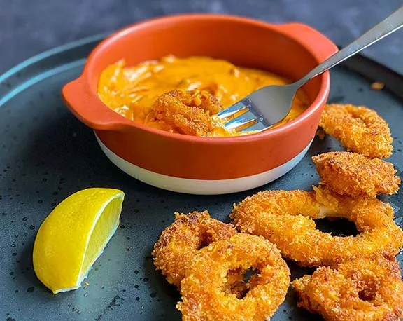 Panko crumbed calamari with harissa mayo.