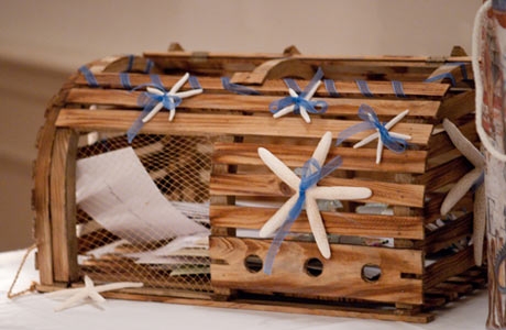 For a beach wedding a clever idea is using a lobster trap with the card 