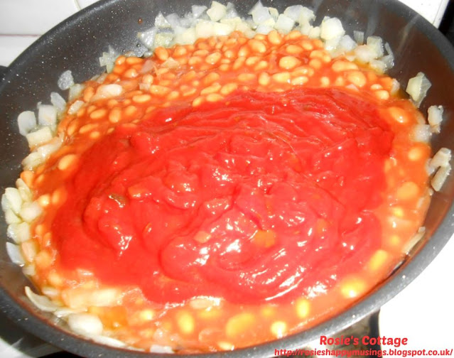 Super easy, super yummy, "dinner-in-a-flash" sausage & bean melt: When the onion is cooked, add the can of baked beans and the jar of pasta sauce.