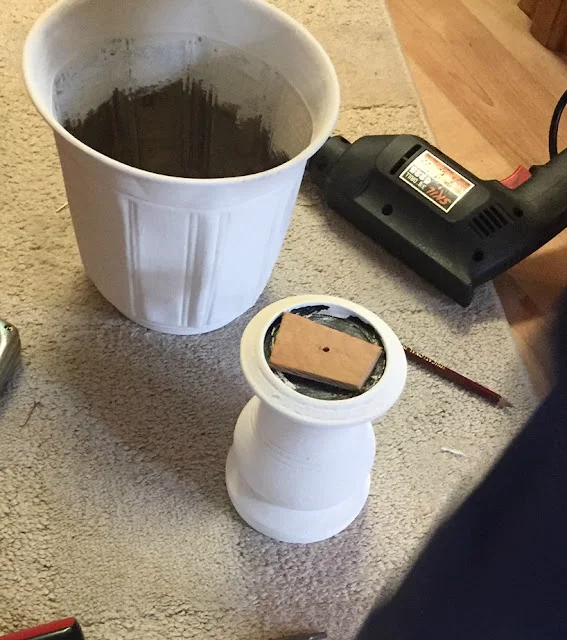 Photo of a white painted flowerpot and candleholder