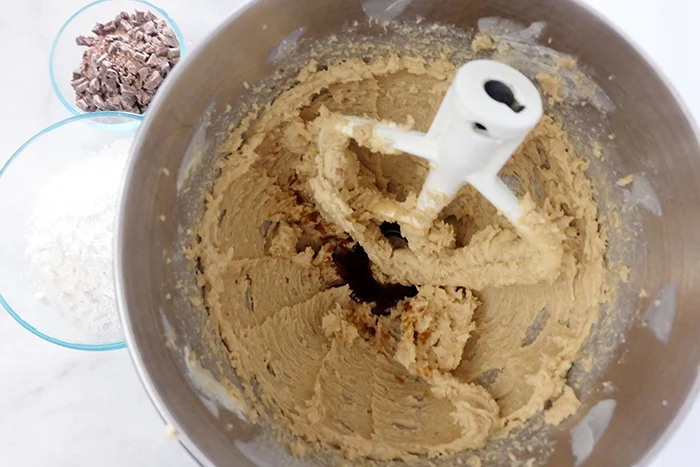 blended butter, sugars, and adding vanilla to mixer bowl