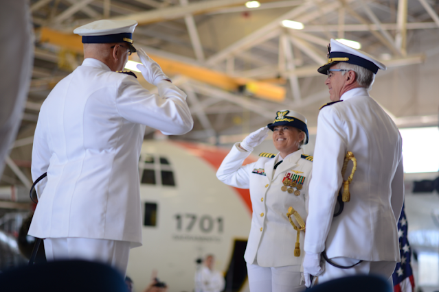 - Capt. Carola J. List (right), new commanding officer of Air Station Sacramento, salutes Capt. Douglas E. Nash (left), as Rear Admr. Todd A. Sokalzuk, Commander of the Eleventh Coast Guard District, stands in the center smiling during a change of command ceremony
