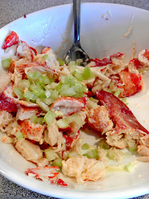 Lobster getting mixed with mayo and chopped celery