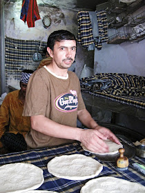 cook making tandoori rotis