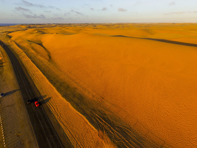 Namibia: Atlantic Coast: sand dunes & ocean aerial photo gallery