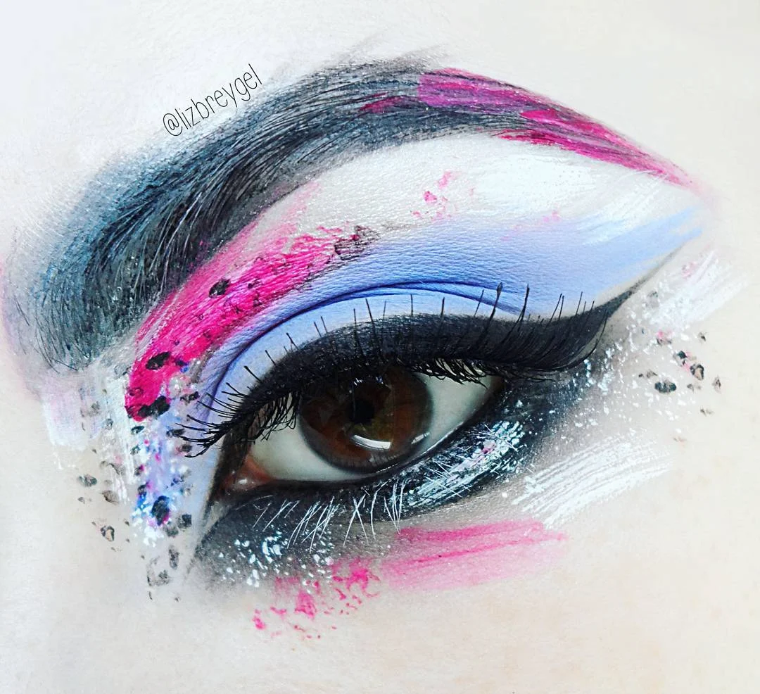 a close-up of brown eye with an editorial makeup look with paint splashes