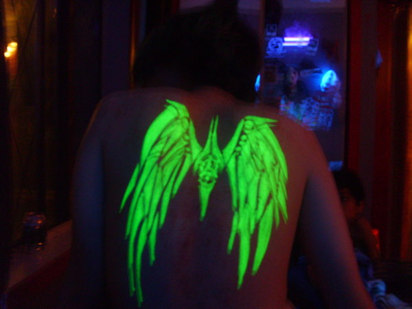 A tribal wings tattoo drawn freehand with a highlighter.