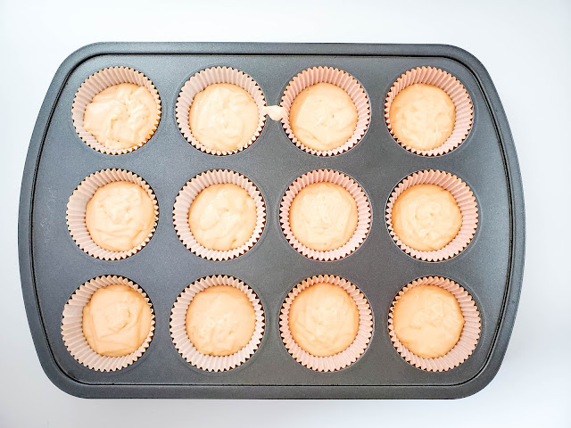 cupcake batter in liners in a cupcake pan.