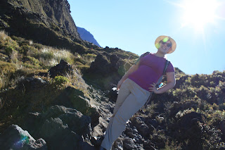 Picture of me, from below, wearing a big straw hat and grinning.