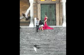 In Italy, a woman was seen posing almost naked for a photoshoot on the steps of the historic cathedral of Amalfi.