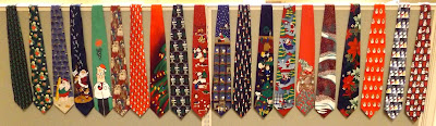 Picture of a row of Christmas ties hanging on a cubicle wall