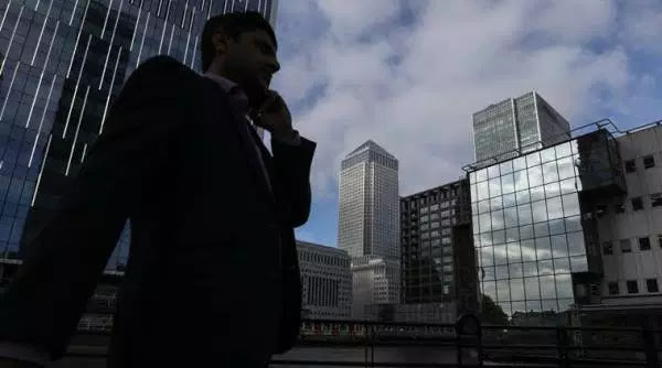 A pedestrian walks in the Canary Wharf business, financial and shopping district in London, UK, on Thursday, June 5, 2018. The owners of a Canary Wharf skyscraper leased to Citigroup Inc. are seeking to refinance the 661 million-pound (2 million) loan used to buy it five years ago, two people with knowledge of the plan said.