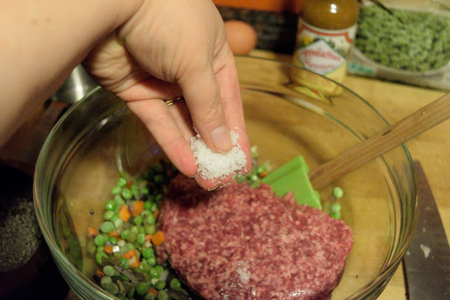 The ground beef and more salt being added to the sauteed vegetables.