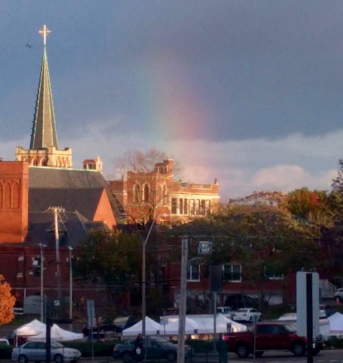 Rainbow in background, Arlington Farmers Market in foreground church steeple at left