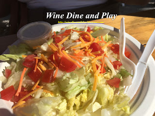 Mixed greens, tomatoes, and cheese make up the house salad at Paradise Grille with choice of dressing