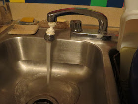 water running from faucet into sink