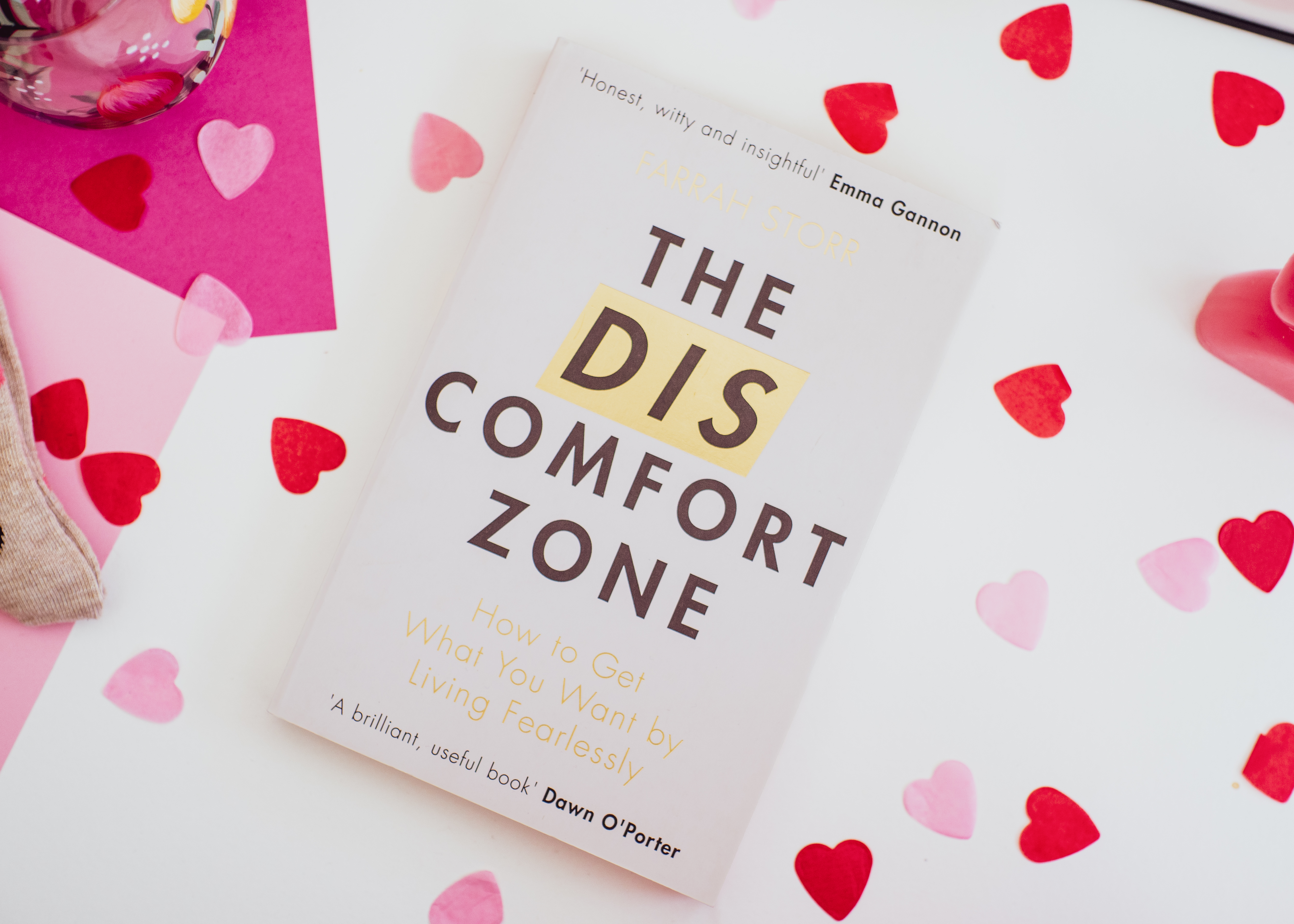 'The Discomfort Zone' by Farrah Storr laying on a white background surrounding with red and pink heart paper confetti