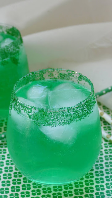 green cocktail with ice and green sprinkles