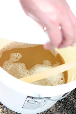 The hop-infused and chilled wort flowing into the fermenation bucket.