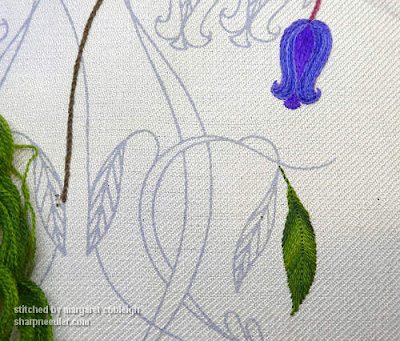Starting to stitch: bluebell in purples and blues and a leaf in variegated green crewel wool