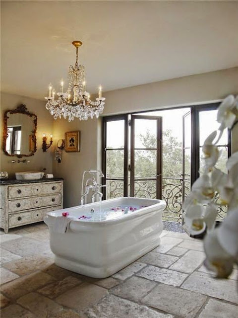 traditional rustic master bathroom stone tiles ornate crystal chandelier